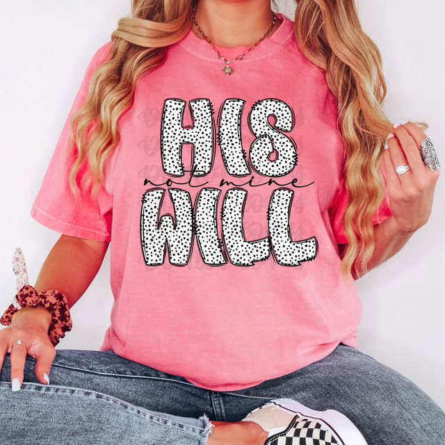 His Will Not Mine DTF Heat Transfer, close-up of pink T-shirt with bold black and white polka dot lettering saying 'His Not Mine Will' worn by a woman with long blonde hair, accessorized with jewelry and casual denim jeans.