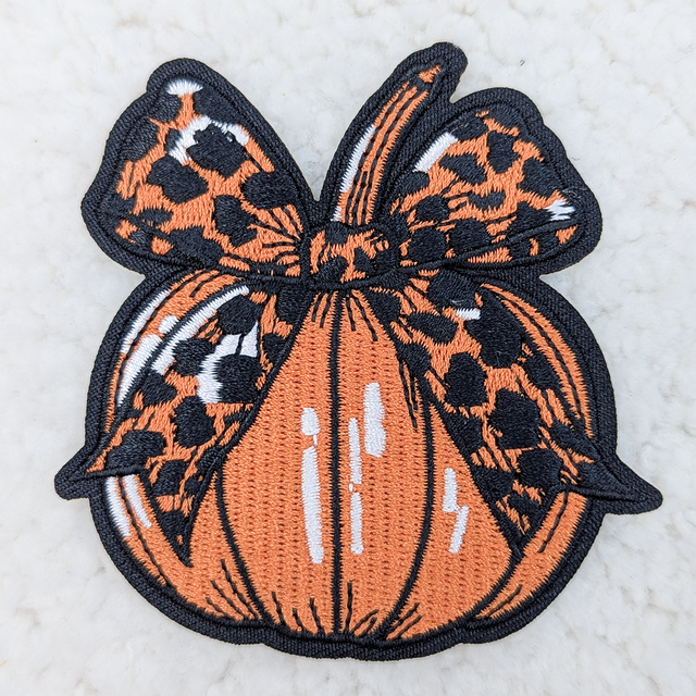 Leopard BOW Pumpkin Embroidered HAT/POCKET Patch, embroidered patch featuring a leopard bow on a pumpkin.