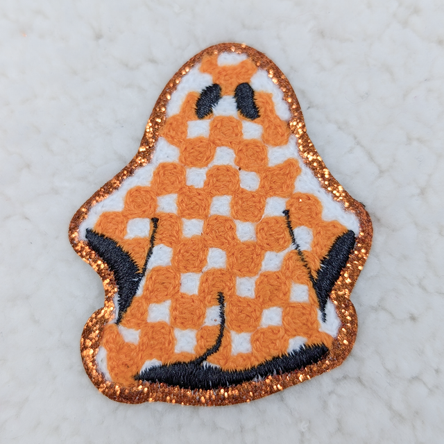 Checkered Ghost Embroidered Chenille HAT/POCKET Patch, embroidered patch featuring a checkered ghost design with orange, white, black, and glitter accents.