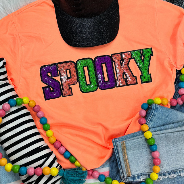 Sequins Spooky Patch, colorful sequin Halloween patch on an orange t-shirt with accessories.