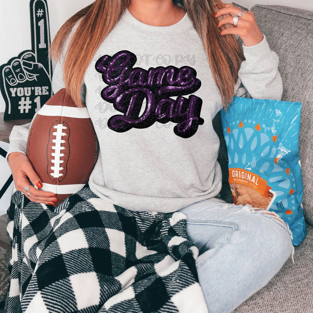 FAUX Purple Sequins Game Day Patch DTF Heat Transfer, a purple sequin patch with a game day design on a woman's gray sweatshirt.