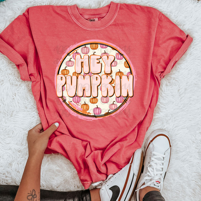 Hey Pumpkin Retro DTF Heat Transfer, pink t-shirt with a Halloween pumpkin design and the phrase 'Hey Pumpkin' in large bubble letters.
