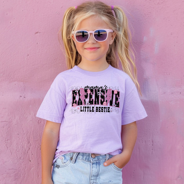 Mama's Expensive Little Bestie DTF Heat Transfer, pink girl wearing a lavender T-shirt with a decorative design and sunglasses photop for product showcase.