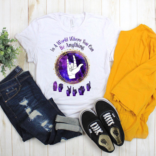 In a world where you can be anything, Be Kind Sign language Sublimation Transfer T-shirt, featuring a hand sign for 'be kind' and purple cosmic background.