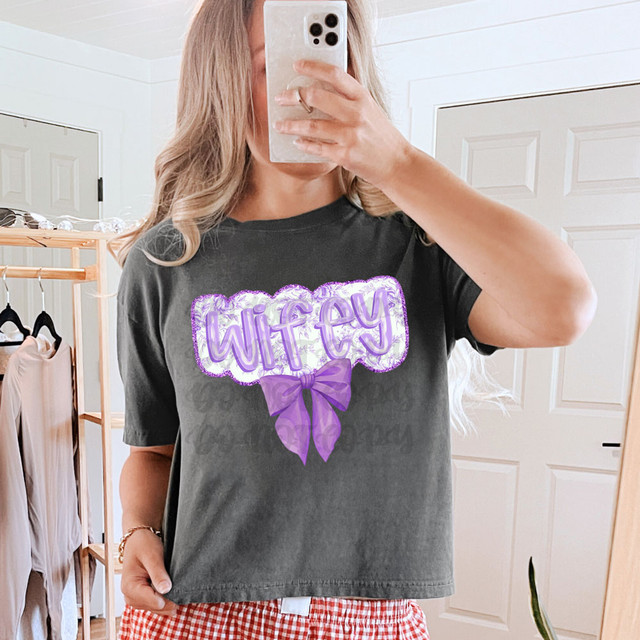 Wifey Purple Chinoiserie DTF Heat Transfer, purple text with a bow graphic on a black t-shirt.