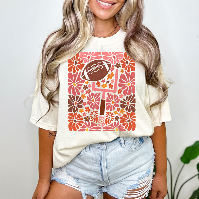 Football Floral DTF Heat Transfer, colorful floral and football themed design printed on a white t-shirt.