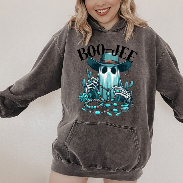 Boo-Jee Turquoise Ghost DTF Heat Transfer, illustrated ghost wearing a hat and jewelry, on a dark gray hoodie.