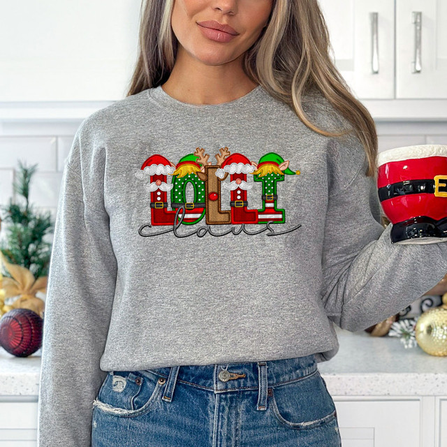 Lolli Claus Faux Embroidery DTF Heat Transfer, festive Christmas design on a gray sweatshirt featuring elves, reindeer, and Santa's hat with the word 'Joy'