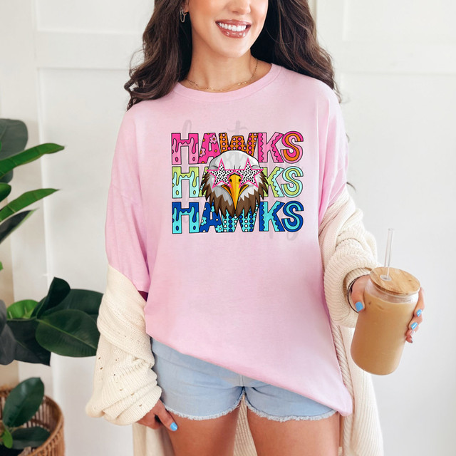 Hawks Stacked Pattern DTF Heat Transfer, colorful and detailed eagle face with sunglasses and the word THANKS in vibrant multicolored lettering on a pink t-shirt.