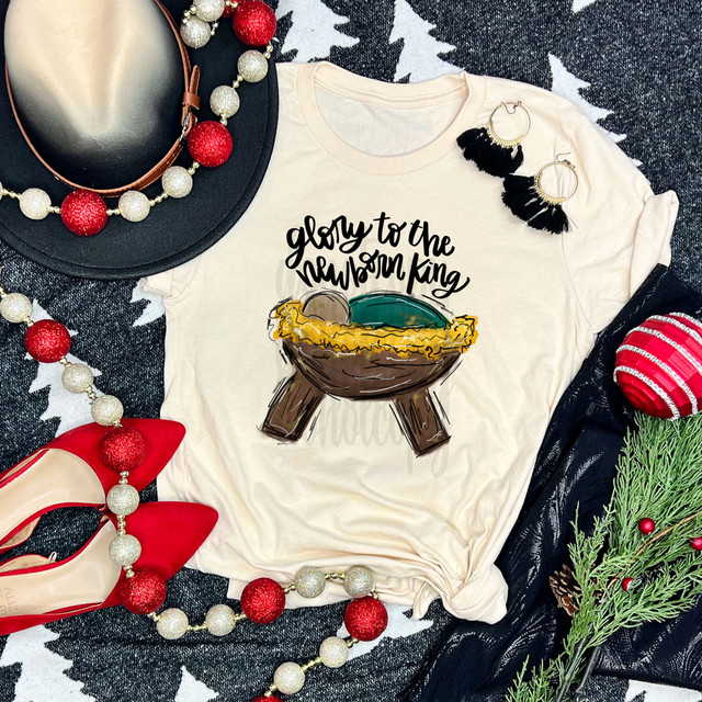 Glory To The Newborn King DTF Heat Transfer, Christmas-themed illustration on a T-shirt with festive accessories.