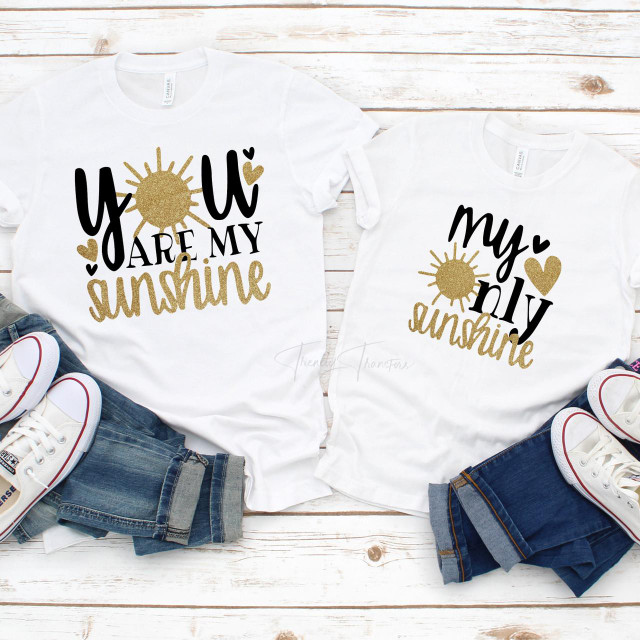 My Only Sunshine, mommy and me matching outfit sublimation transfer t-shirts with sun and heart designs on white fabric, paired with denim jeans and white sneakers.