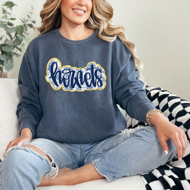 Hornets Blue Floral DTF Heat Transfer, woman wearing a sweatshirt with the Hornets logo and floral pattern.