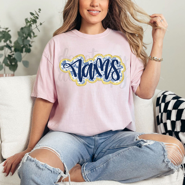 Rams Blue Floral DTF Heat Transfer, a vibrant blue floral design with gold accents on a pink t-shirt.
