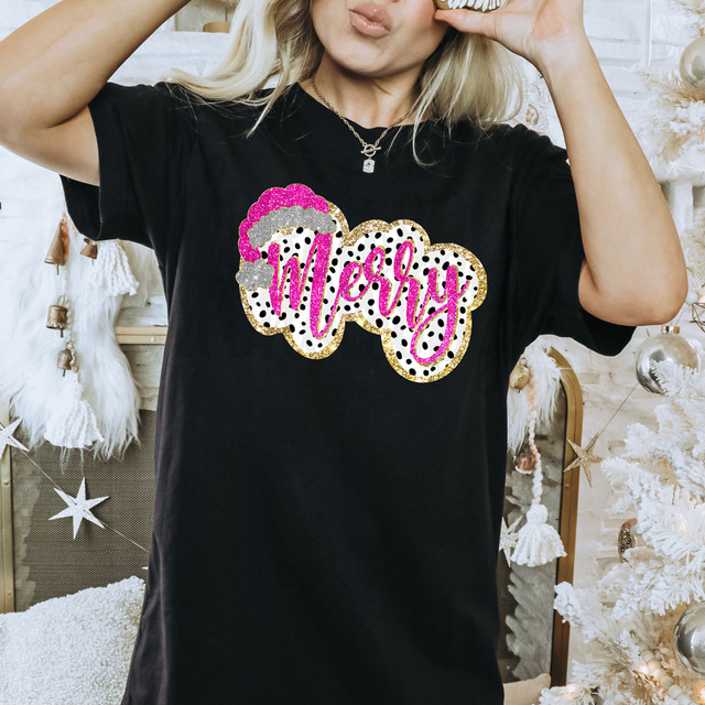 Pink Merry Faux Glitter DTF Heat Transfer, pink glitter text with a dotted pattern and a fluffy cloud design, applied on a black T-shirt.