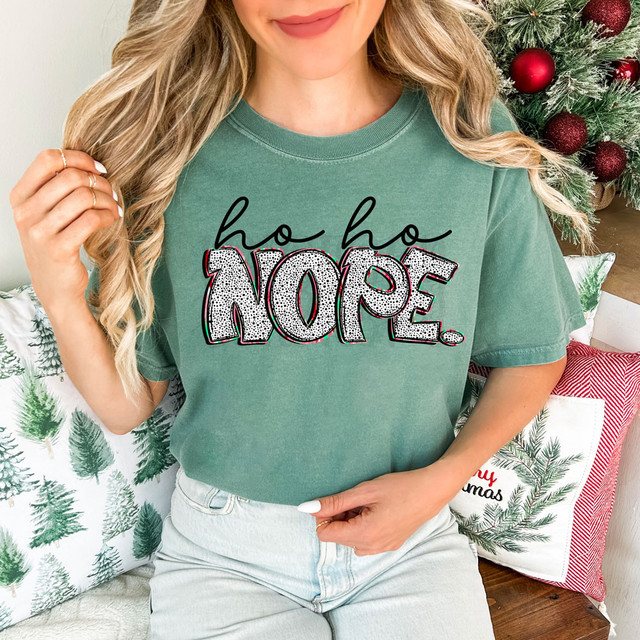 Ho Ho Nope, DTF Heat Transfer, featuring a woman wearing a green T-shirt with the text "ho ho NOPE" in festive style, used for creative holiday apparel and decoration.