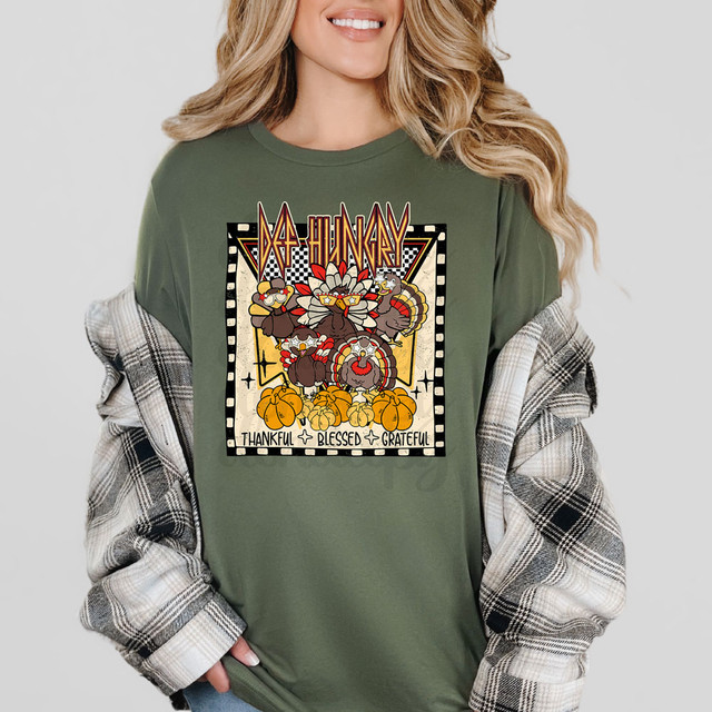 Def Hungry Turkeys DTF Heat Transfer, colorful Thanksgiving-themed design on a green T-shirt featuring animated turkeys, pumpkins, and text with words like thankful, blessed, and grateful.