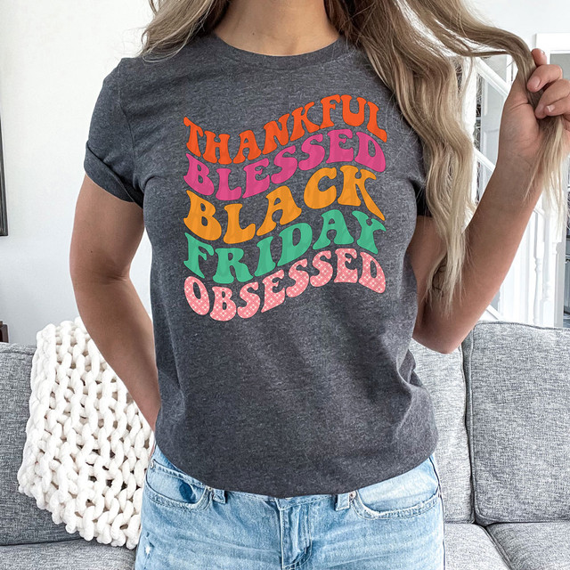Thankful Blessed Black Friday Obsessed DTF Heat Transfer T-shirt, colorful graphic design on dark gray fabric.
