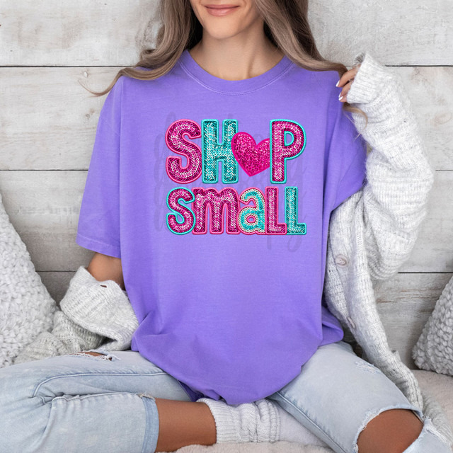 Shop Small Faux Sequins DTF Heat Transfer, colorful sequin embellished text on purple T-shirt featuring 'SHOP SMALL' with a heart symbol in the middle.