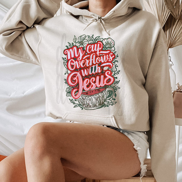 My Cup Overflows With Jesus DTF Heat Transfer, colorful Christian-themed design on a hoodie.