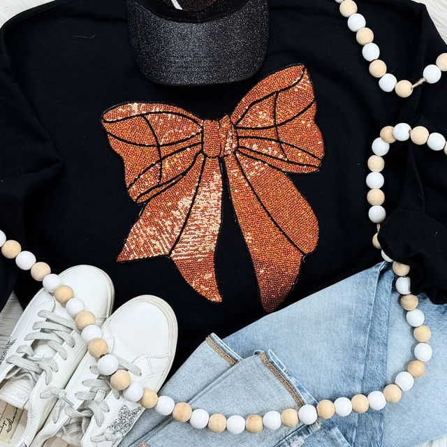 Sequins Basketball Bow Patch, orange sequin butterfly patch with black outlines on a black sweatshirt