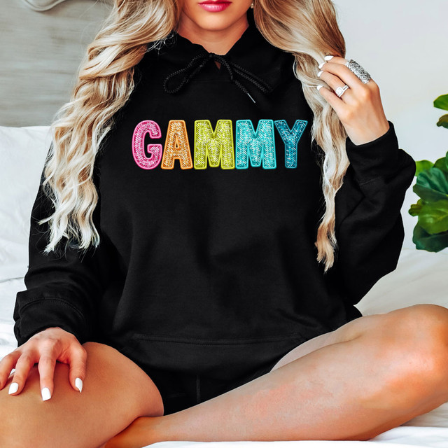 Bright Groovy Gammy Faux Sequins DTF Heat Transfer, a colorful sequin design on a black hoodie.