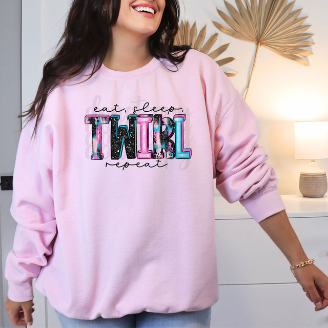 Eat, Sleep, Twirl Repeat DTF Heat Transfer, colorful and vibrant unicorn-themed design on a pink sweatshirt.