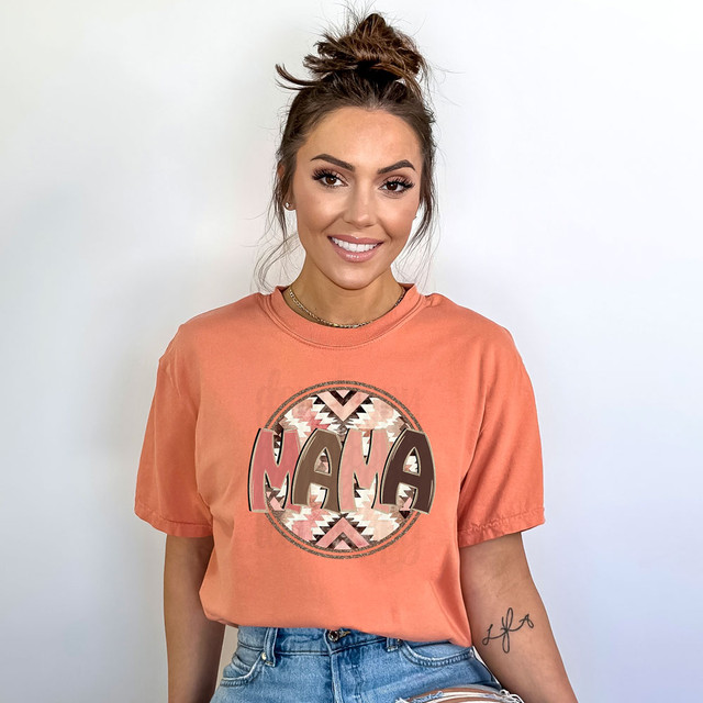 Mama Aztec DTF Heat Transfer, woman wearing a peach t-shirt with a colorful Mama Aztec design.