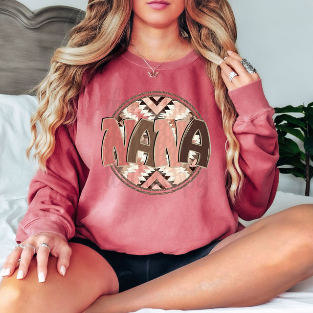 Nana Aztec DTF Heat Transfer, stylish and colorful Aztec pattern graphic on a pink sweatshirt worn by a woman.