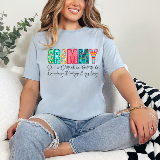 Grammy She Is Clothed In Gratitude Counting Blessings Every Day DTF Heat Transfer, a woman wearing a light blue T-shirt with colorful, decorative text and a heartfelt message.