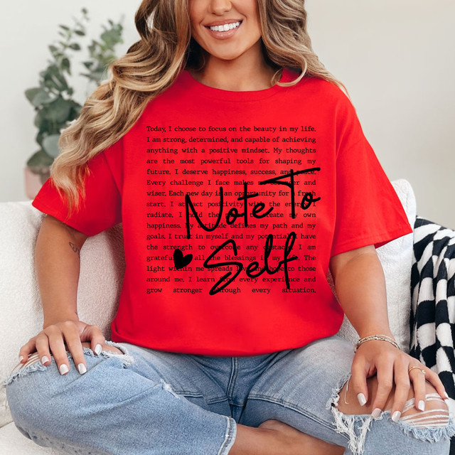 Note To Self BLACK DTF Heat Transfer, a black heat transfer design with motivational message on a red t-shirt worn by a woman sitting on a sofa.