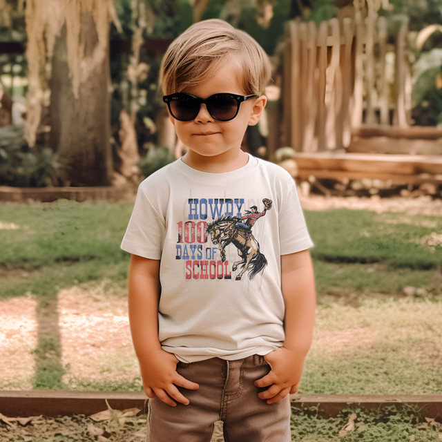Howdy 100 Days Of School DTF Heat Transfer, a kid wearing a T-shirt with a cowboy riding a horse and celebrating the 100th day of school.