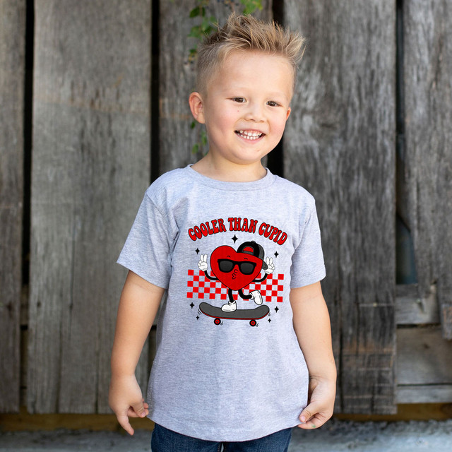 Cooler Than Cupid DTF Heat Transfer, animated heart character wearing sunglasses and skateboard, with text, fun and playful design for clothing decoration.