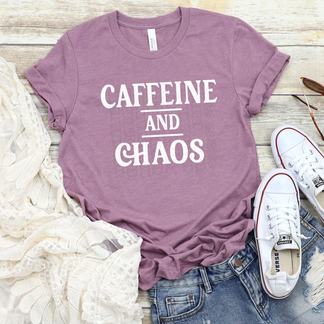 Caffeine & Chaos White DTF Heat Transfer, white heat transfer design on mauve T-shirt displayed with casual accessories.