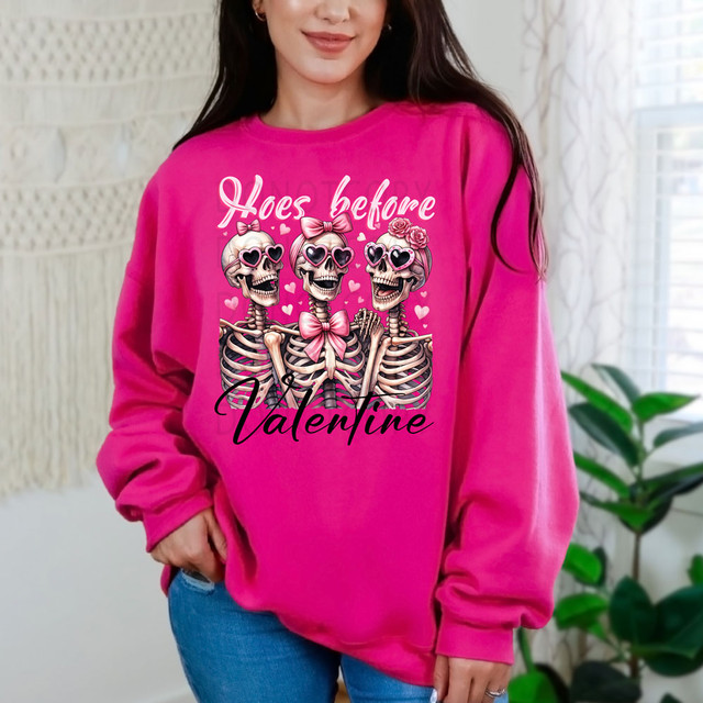 Hoes Before Valentine DTF Heat Transfer, pink sweatshirt with skeletons wearing sunglasses, bows, and roses, celebrating Valentine's Day in a fun and edgy style.