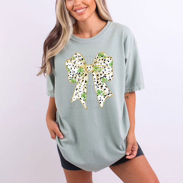 Shamrock Black Dot Bow DTF Heat Transfer, a decorative bow with green shamrocks and black dots on a white background with golden outline.