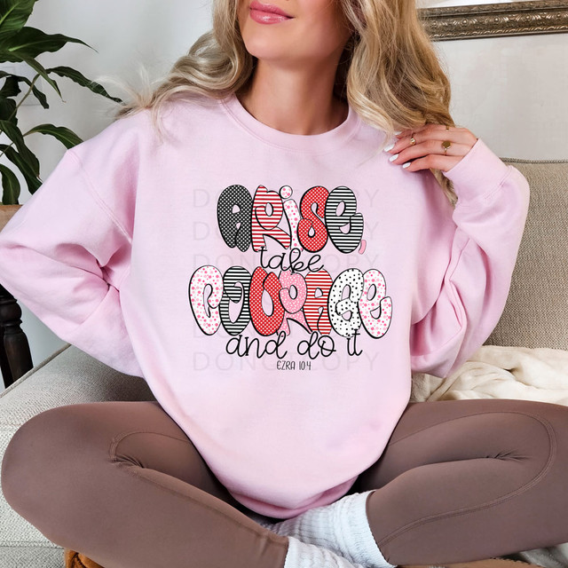Arise Take Courage And Do It DTF Heat Transfer, colorful design on a pink sweatshirt with inspiring quote and decorative text patterns.