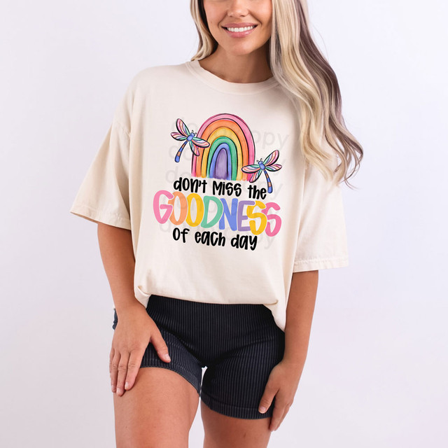 Don't Miss The Goodness Of Each Day DTF Heat Transfer, colorful rainbow and dragonfly design on a woman's beige t-shirt.