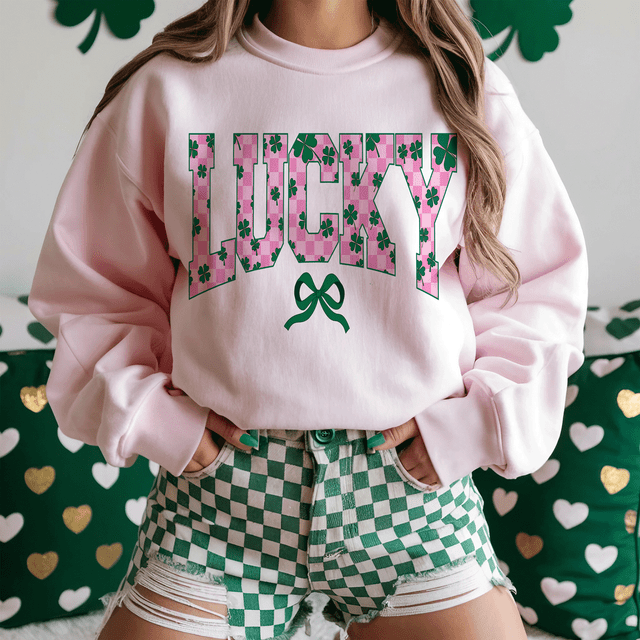 Dark Green Lucky Checkered DTF Heat Transfer on a pink sweatshirt with clover and bow design.