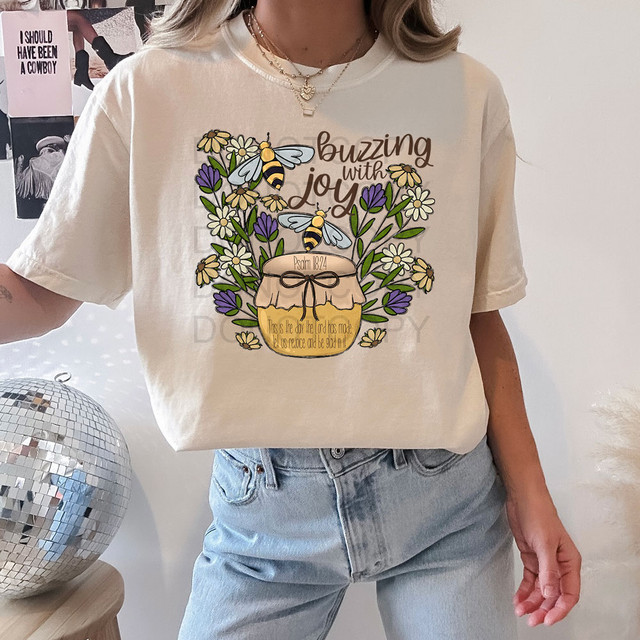 Buzzing With Joy DTF Heat Transfer, colorful floral design with bees, and biblical quote on a white t-shirt.