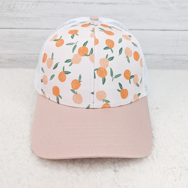 Peach Patterned Trucker Style Hat, a stylish cap with a peach fruit pattern on the front panel and a pale pink curved brim.