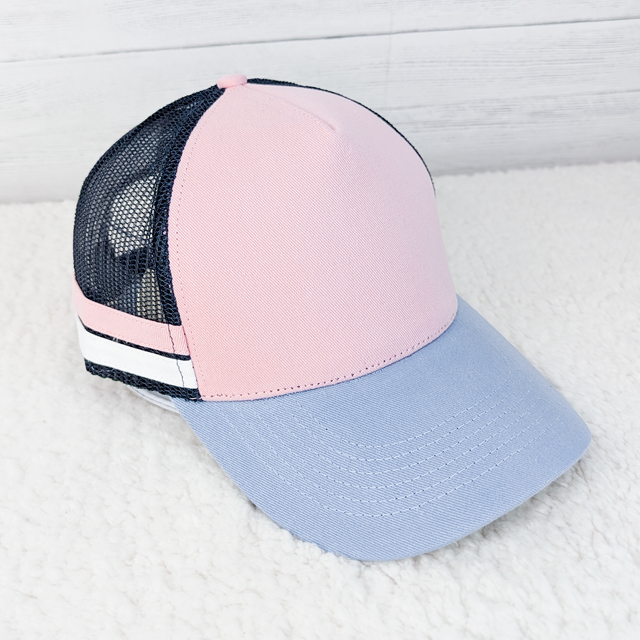 Pink and Navy Trucker Style Hat, a stylish baseball cap featuring a pink front panel, navy mesh back, and a grey curved brim.