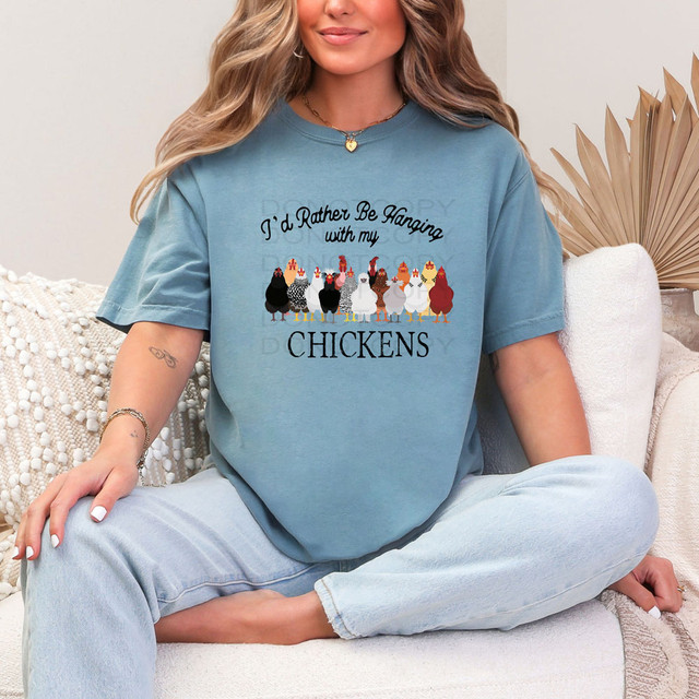 I'd Rather Be With My Chickens DTF Heat Transfer, woman wearing a blue t-shirt with a chicken graphic and humorous phrase.