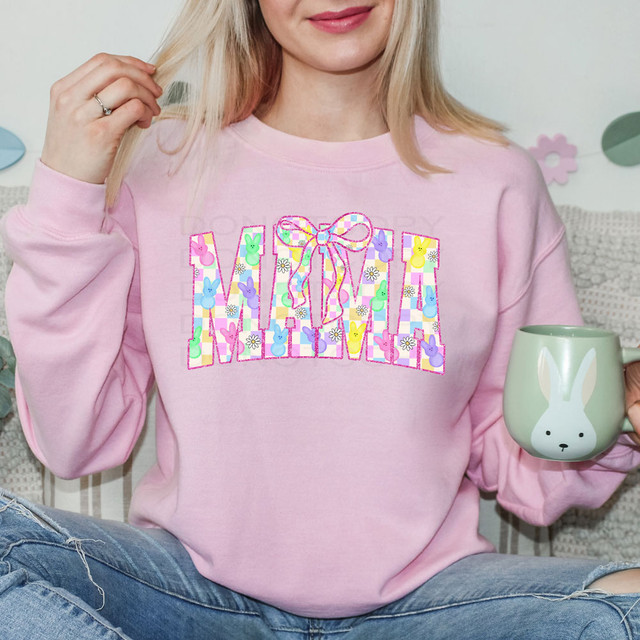 Mama Checker Easter DTF Heat Transfer on a pink sweatshirt featuring colorful Easter-themed bunny and floral designs.