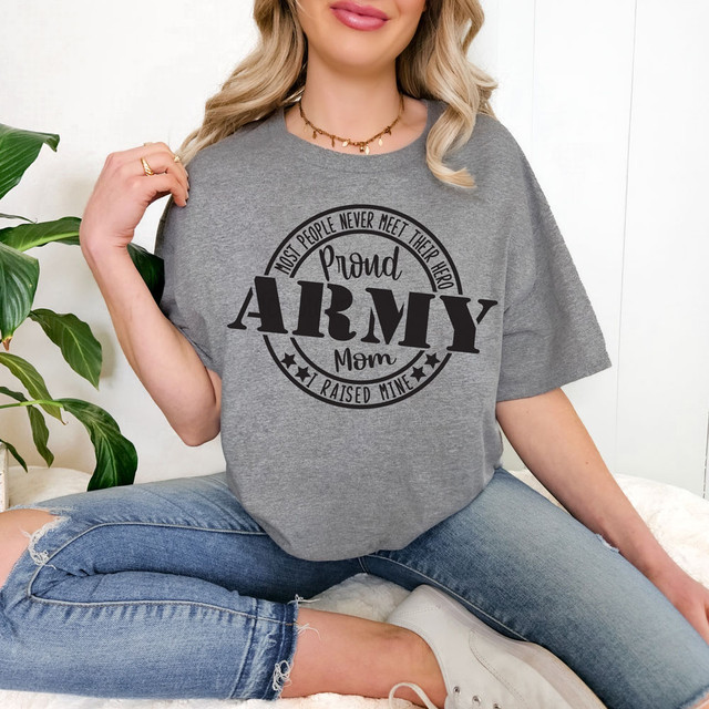 Proud Army Mom Military DTF Heat Transfer, woman wearing a gray t-shirt with black text that says 'Most People Never Meet Their Hero Proud Army Mom Raised Mine'.