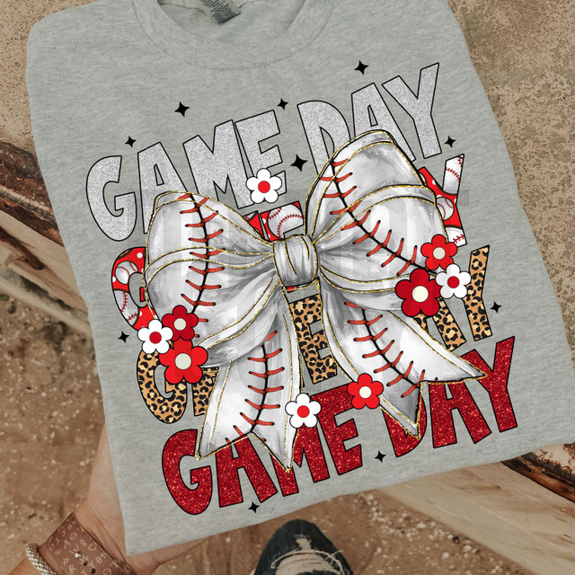 Baseball Game Day Coquette DTF Heat Transfer, a graphic design featuring a large baseball-themed bow with red and white flowers, glittery text, and baseball stitches on a gray T-shirt.