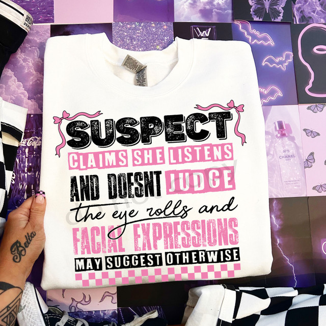 Suspect Claims She Listens DTF Heat Transfer, white sweatshirt with black and pink text and decorative elements for heat transfer design.