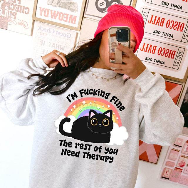 I'm Fucking Fine The Rest Of You Need Therapy DTF Heat Transfer, a person's chest showing a graphic sweatshirt with a black cat, rainbow, and the humorous text.