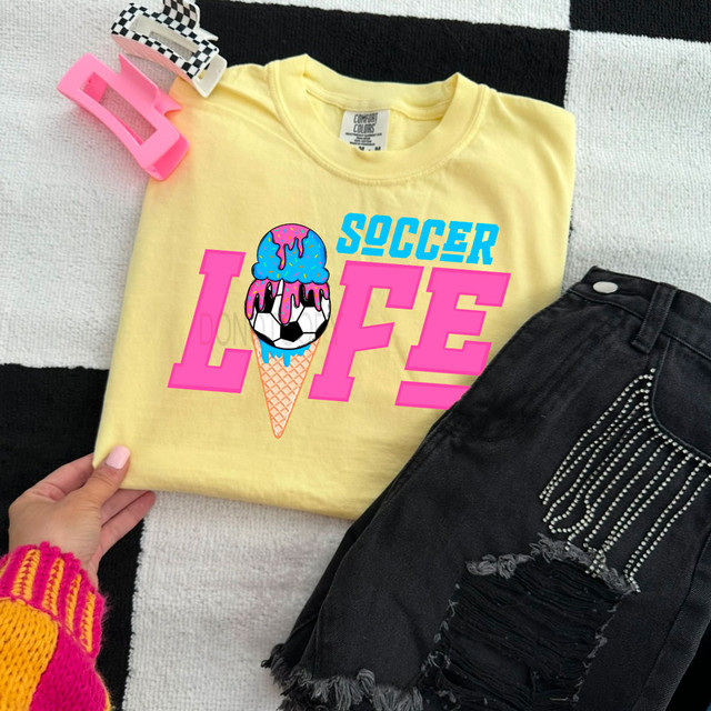 Soccer Life Ice Cream Drip DTF Heat Transfer, colorful ice cream and soccer ball graphic on a yellow t-shirt.