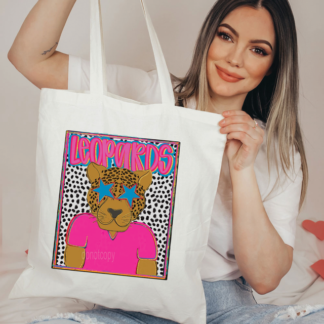Leopards Colorful Mascot DTF Heat Transfer, a vibrant and colorful leopard mascot design with pink, blue, and black accents on a tote bag.