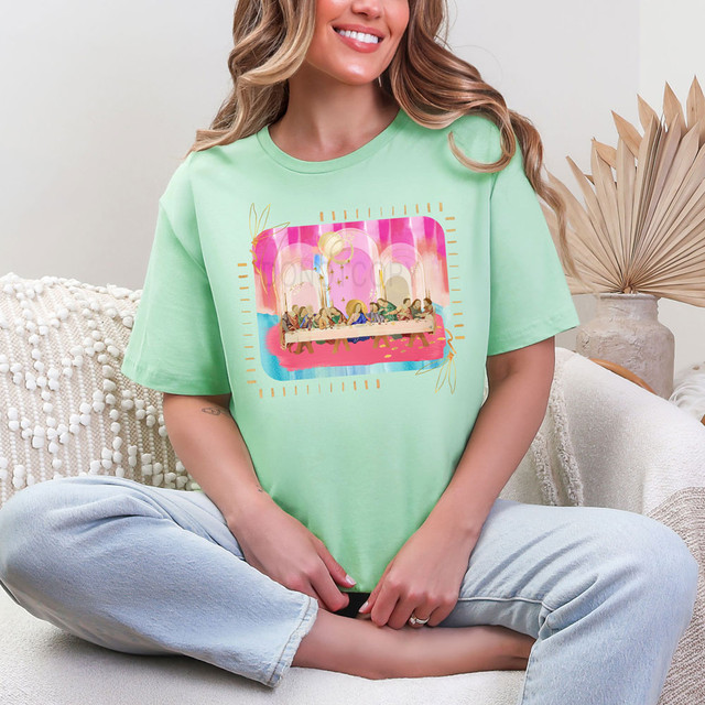 Painted The Last Supper DTF Heat Transfer, colorful artistic print of Jesus and his disciples at the Last Supper on a woman's pastel green T-shirt.